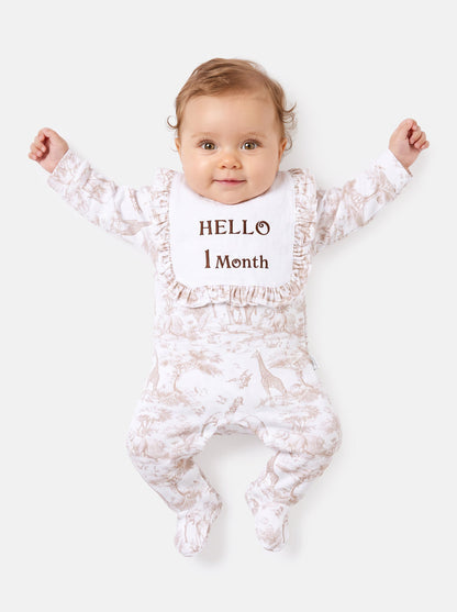"Hello 1,3,6,12 Months" Embroidered Baby Grow with Frilled Bib - Safari Collection - Beige